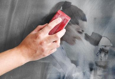 An image of a woman looking through a microscope being erased on a blackboard. To illustrate the rise in teaching-only contracts, limiting career opportunities for research-focused staff.
