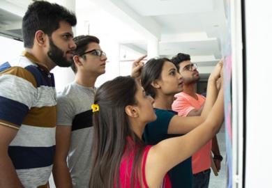 Indian students look at their exam results