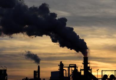Smoke billows from factory chimneys