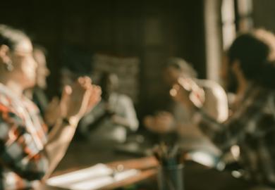An unfocused image of a faculty meeting