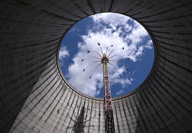 Visitors on a fairground ride rising into the sky from what was a nuclear fast breeder, at the amusement park in Kalkar, Germany, 2023. To illustrate German excellence strategies boosting the research capacity of its top institutions.