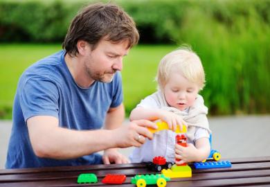 Father and child playing with blocks
