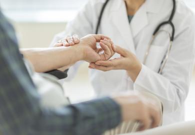 Female doctor and senior man illustrating news article about increase in admissions of women to Japanese medical schools