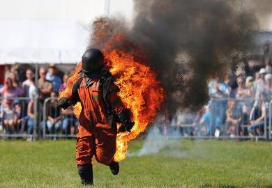 Man in hazard suit on fire