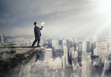 A man with a megaphone on a rooftop, symbolising free speech