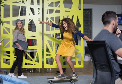 Woman skateboarding in office