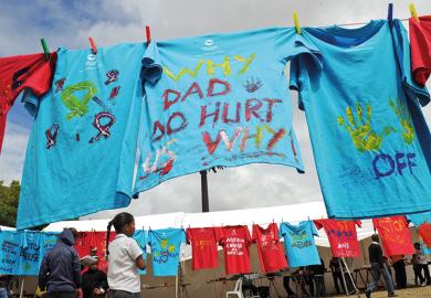T-shirts painted with messages of support hang on clothes lines, South Africa. Part of the 16 Days of Activism of No Violence Against Women and Children campaign