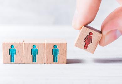 A cube with a woman on it being added to three with men on them, symbolising gender equality
