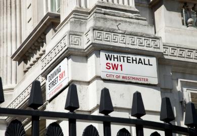 Street signs on the corner of Downing Street and Whitehall. Downing Street is the home of the British Prime Minister and government