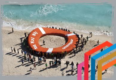 People flocking around giant lifebelt to suggest how business can build coalitions to promote sustainability and rescue the planet