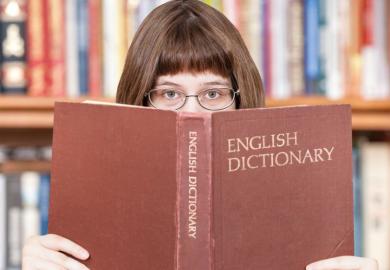 Girl looking over dictionary
