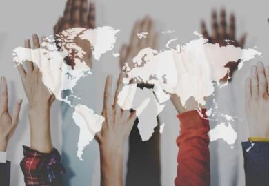 Hands raised, superimposed on a map of the world
