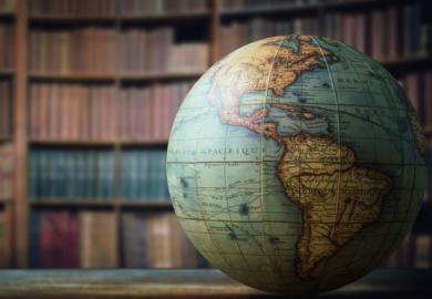 A globe in a library, symbolising internationalisation of higher education