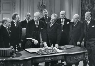 Group of old men signing paperwork