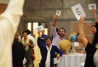 Group of people bidding at auction