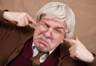 Grumpy man with fingers in ears