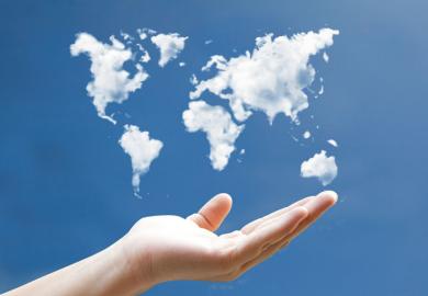 Hand holding world map drawn in clouds