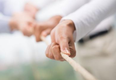 Hands pulling rope, tug of war, teamwork