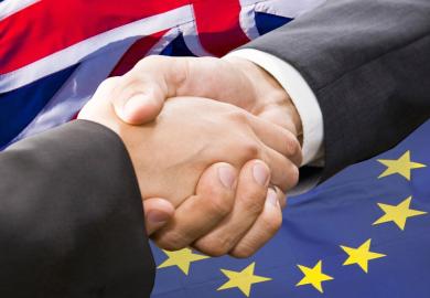 Handshake in front of European Union and United Kingdom flags
