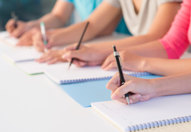 Students writing by hand
