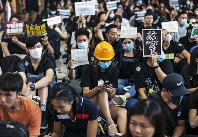 Woman in hard hat amid Hong Kong protest