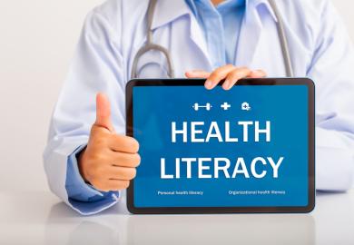 A doctor holding a "health literacy" sign