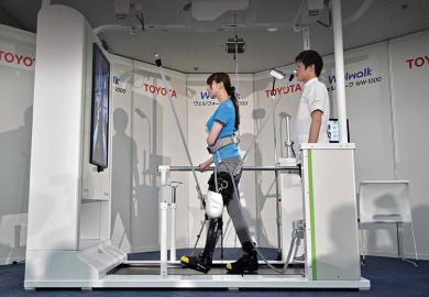 A model demonstrates how the rehabilitation-assist robot Welwalk WW-1000, developed by Japan’s Toyota Motor Corporation