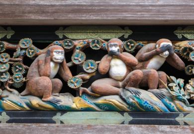 Monkeys in the "hear no evil" pose