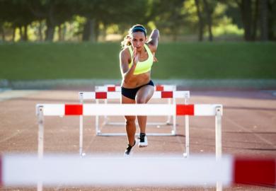 A woman jumping hurdles, illustrating meeting learning outcomes