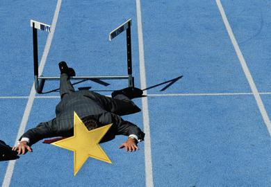 Hurdler flat on his face with gold star