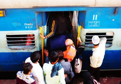 People crowd onto an Indian train, symbolising university admissions