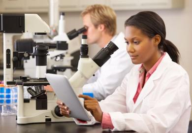A black female scientist working in a lab