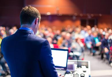Speaker giving presentation at conference