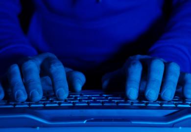 A man types on a computer