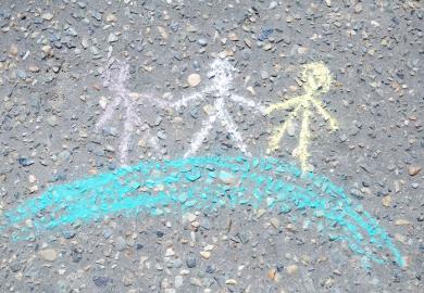 Chalk figures holding hands on a globe