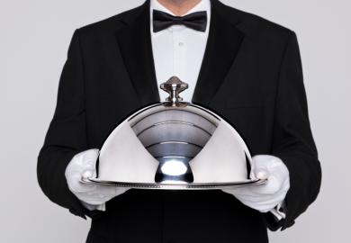 Waiter holding a silver cloche