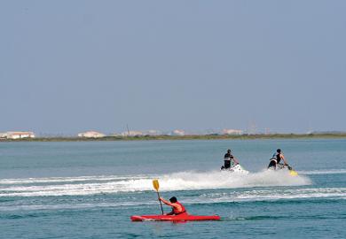 Kayaker and jet skiiers