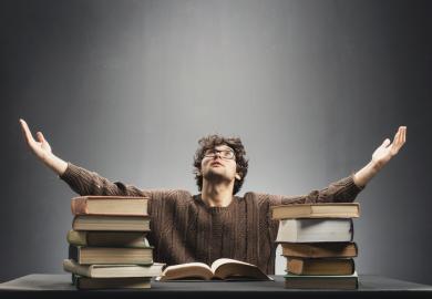 A man with a pile of books, symbolising Lifelong learning