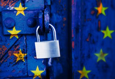 A padlocked door with the EU flag on it
