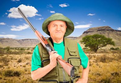 Male hunter holding shotgun