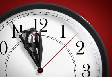Man pushing against clock hands