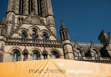 A banner on Manchester town hall reading "Manchester Together", commemorating the anniversary of the Manchester Arena bomb.