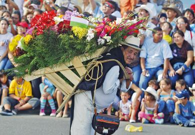 A man with a lot of flowers on his back