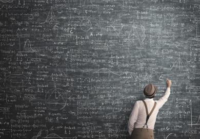 A maths teacher with a huge blackboard