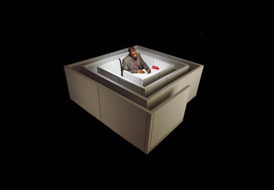 Floating in space, a black man sits at a desk in the middle of a maze