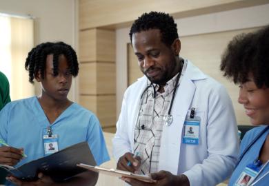 A Black doctor teaches two Black students