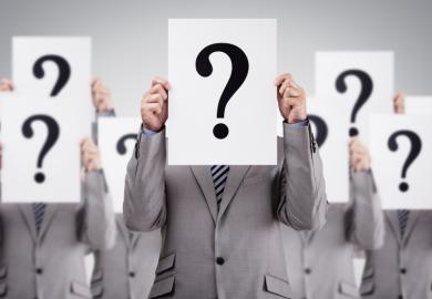 Men in suits holding question marks