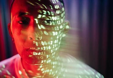 Numbers projected onto the face of an Asian man, symbolising metrics obsession
