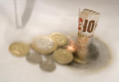 Money washing down the drain, symbolising the diminishing graduate premium