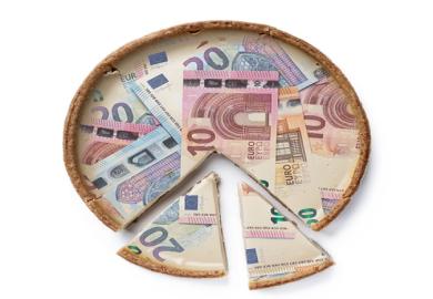 A pie made of Euro notes with cut slices at the bottom